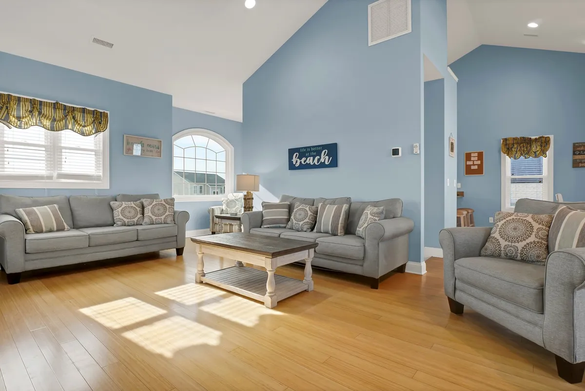 A vibrant and welcoming living area with comfortable sofas, a coffee table, and colorful decorative wall art that creates an inviting setting for relaxation and socializing. The space is ideal for group gatherings and post-game lounging.